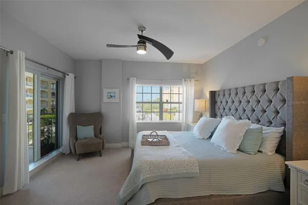 a bedroom with bed and a large window