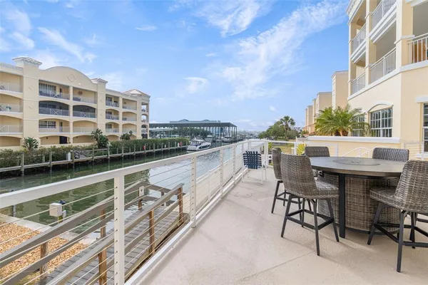 a balcony with table and chairs