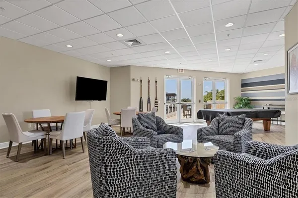 a living room with furniture a rug and a flat screen tv
