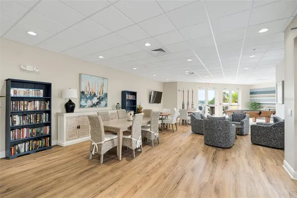 a living room with furniture a wooden floor and a book shelf