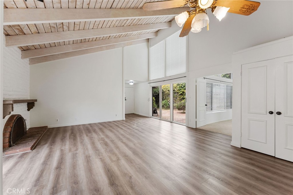 46 Cedar Tree Lane Irvine, CA 92612 - Photo 11 of 44 a view of a livingroom with wooden floor a ceiling fan and windows