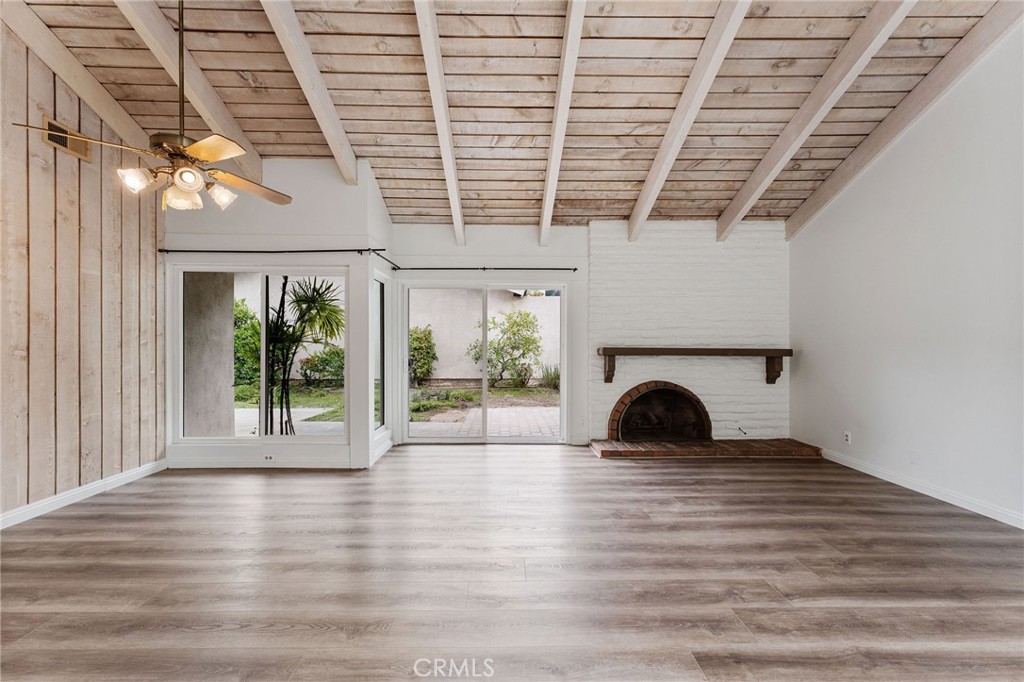 46 Cedar Tree Lane Irvine, CA 92612 - Photo 12 of 44 a view of a room with wooden floor and a fireplace
