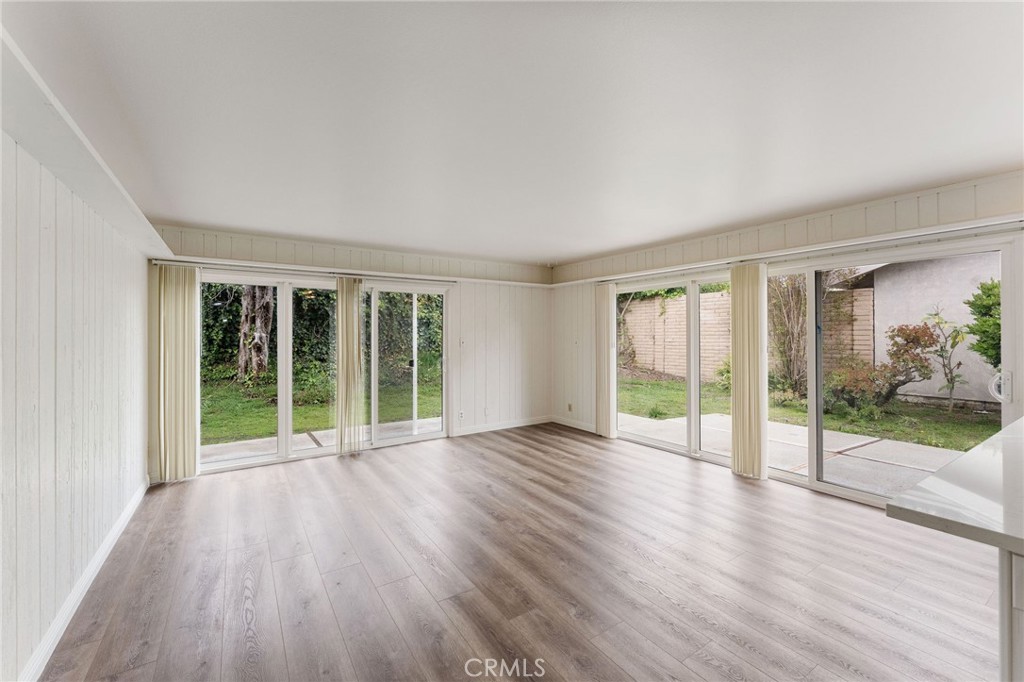 46 Cedar Tree Lane Irvine, CA 92612 - Photo 17 of 44 a view of an empty room with wooden floor and a window
