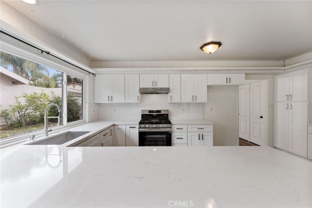 46 Cedar Tree Lane Irvine, CA 92612 - Photo 2 of 44 a kitchen with a stove a sink and a refrigerator