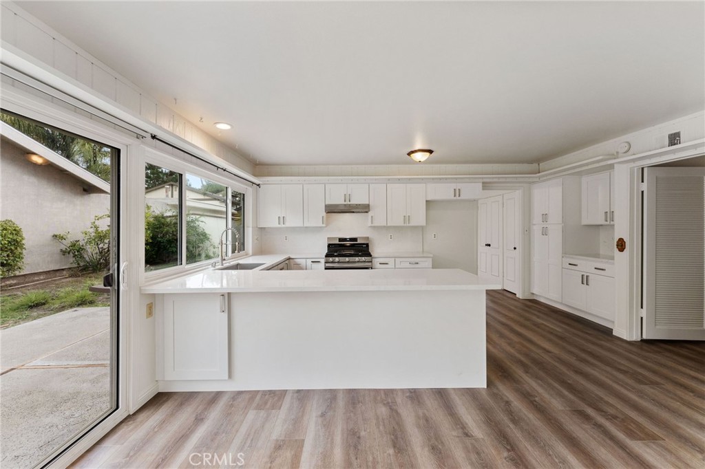 46 Cedar Tree Lane Irvine, CA 92612 - Photo 5 of 44 a living room with stainless steel appliances granite countertop a sink and wooden floor