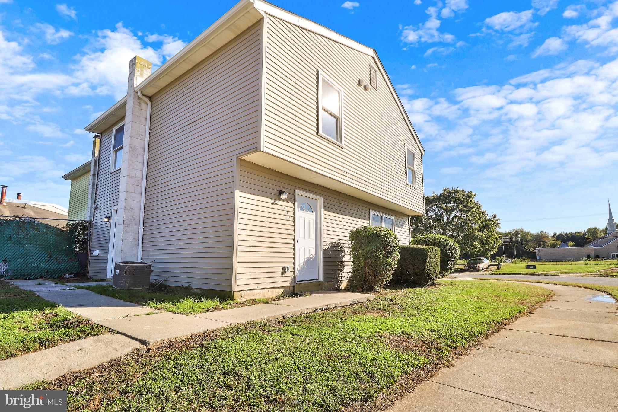 a view of a house with backyard and a tree