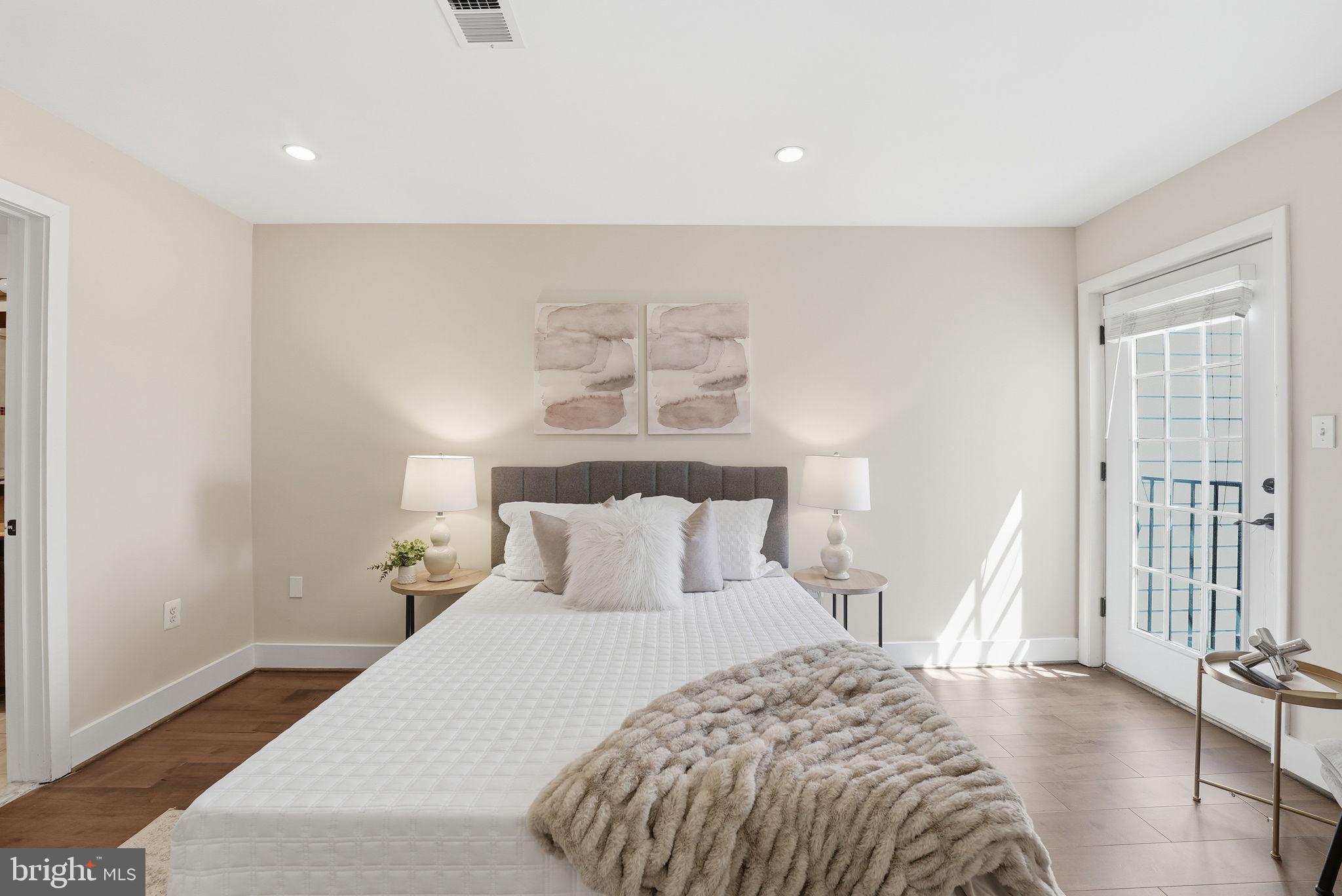 1917 2nd Street Northeast, Unit 301 Washington, DC 20002 - Photo 11 of 20 a bedroom with a bed and wooden floor