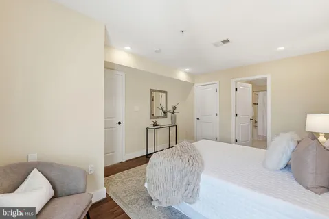 a spacious bedroom with a bed and a couch