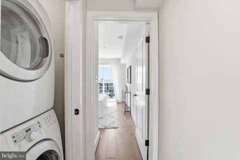 a view of a hallway with a washer and dryer