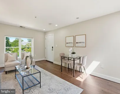 a living room with furniture a table and a large window