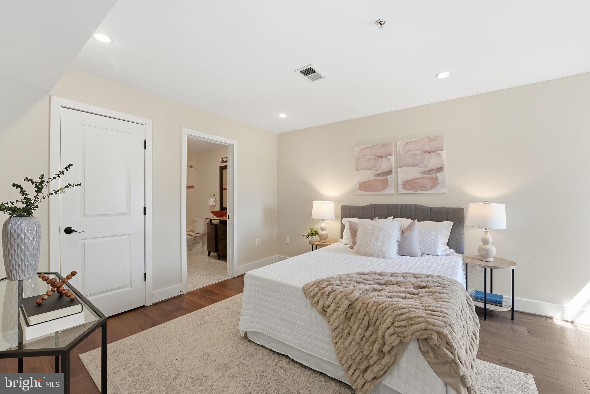 1917 2nd Street Northeast, Unit 301 Washington, DC 20002 - Photo 10 of 20 a bedroom with a bed and a chandelier