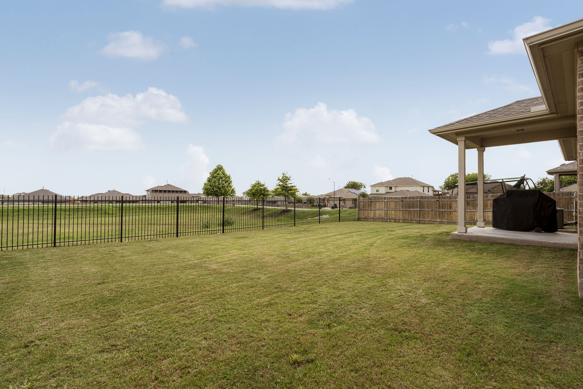 185 Struss Drive Georgetown, TX 78626 - Photo 19 of 23 An ideal fenced backyard with a patio provides abundant space for outdoor activities and relaxation.