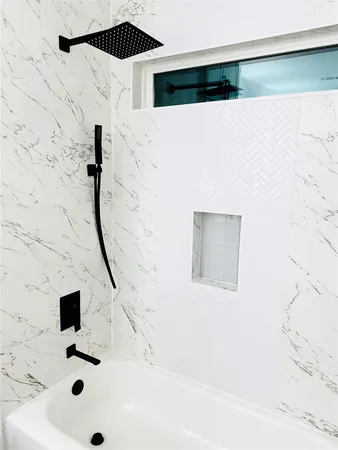 a bathroom with a granite countertop toilet sink and mirror