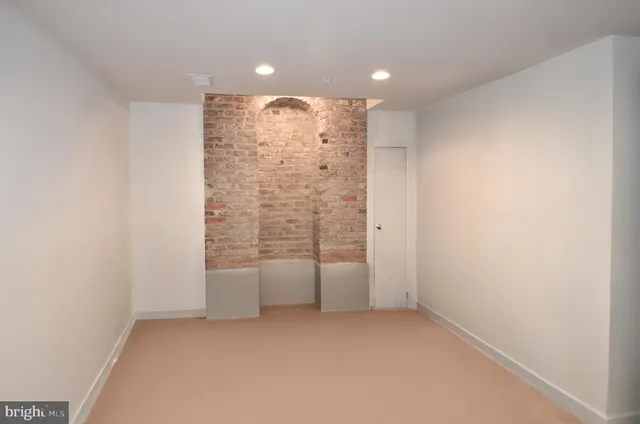a bathroom with a sink and a refrigerator
