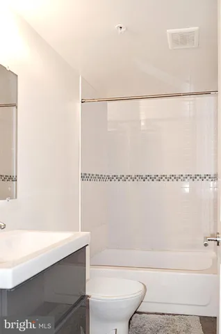 a view of staircase with white walls and window