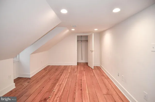 a bathroom with a bathtub shower sink vanity and toilet