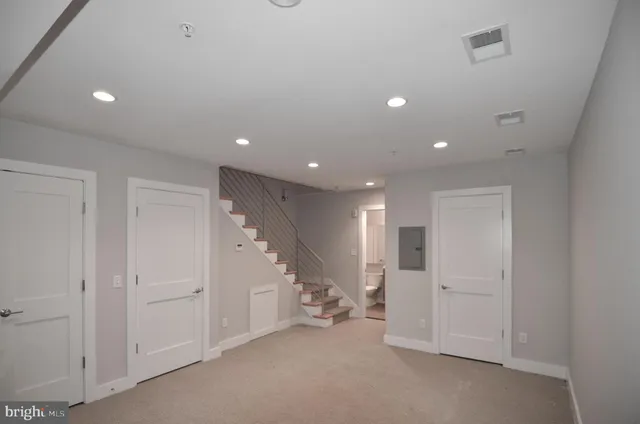 a kitchen with stainless steel appliances kitchen island granite countertop a table chairs sink and microwave