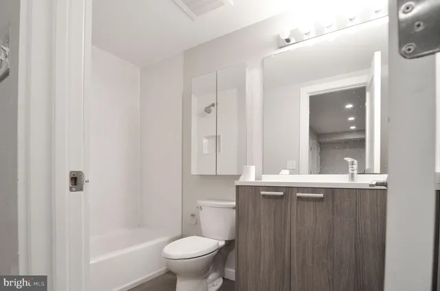 a bedroom with a bed and chair