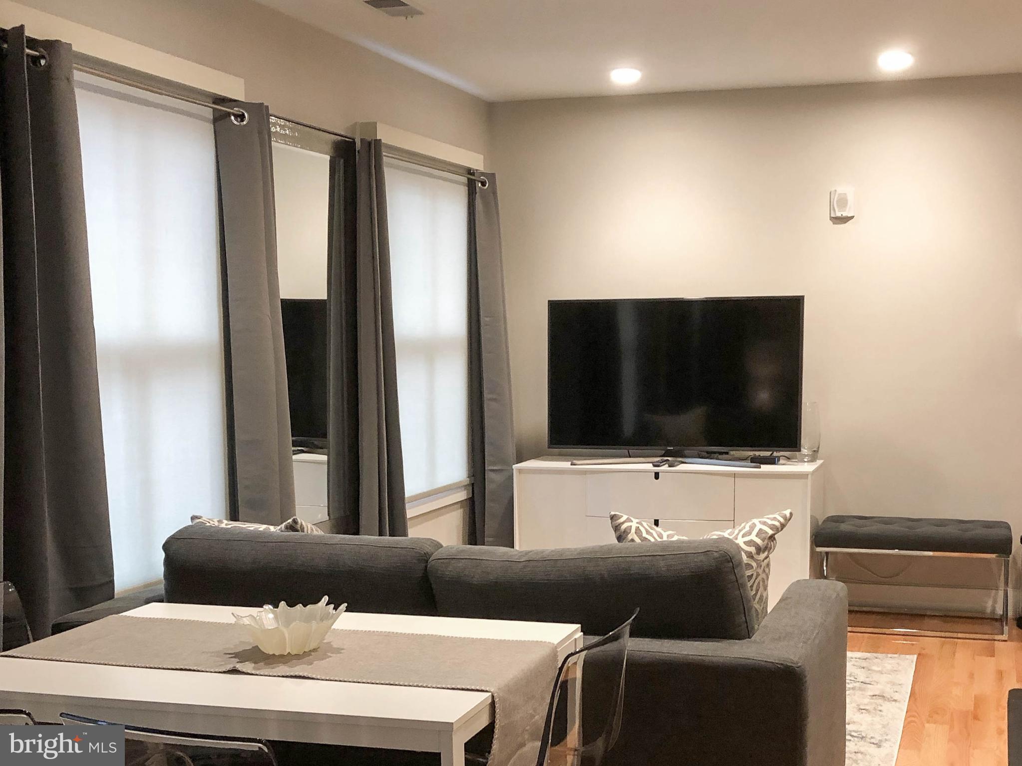 1072 Thomas Jefferson Street Northwest Washington, DC 20007 - Photo 36 of 58 a living room with furniture and a flat screen tv