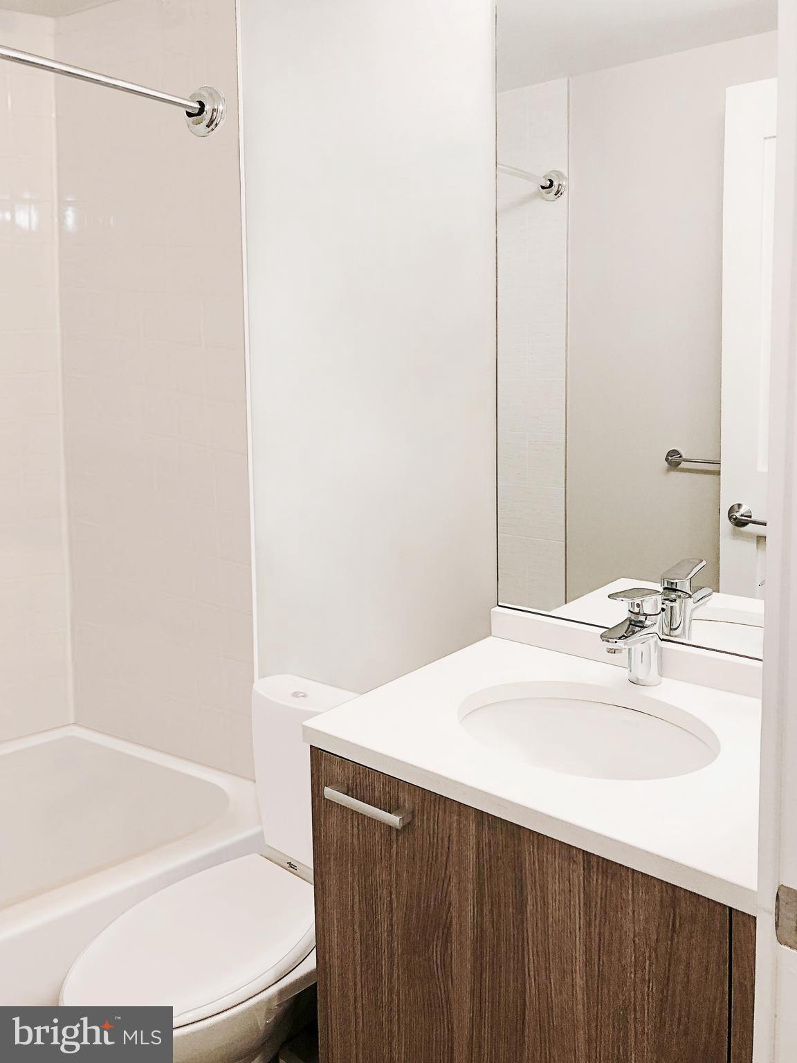 1072 Thomas Jefferson Street Northwest Washington, DC 20007 - Photo 38 of 58 a bathroom with a sink and a mirror