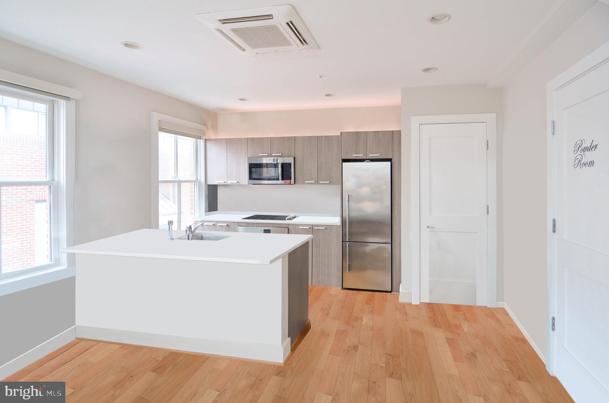 1072 Thomas Jefferson Street Northwest Washington, DC 20007 - Photo 44 of 58 a kitchen with kitchen island sink refrigerator and window