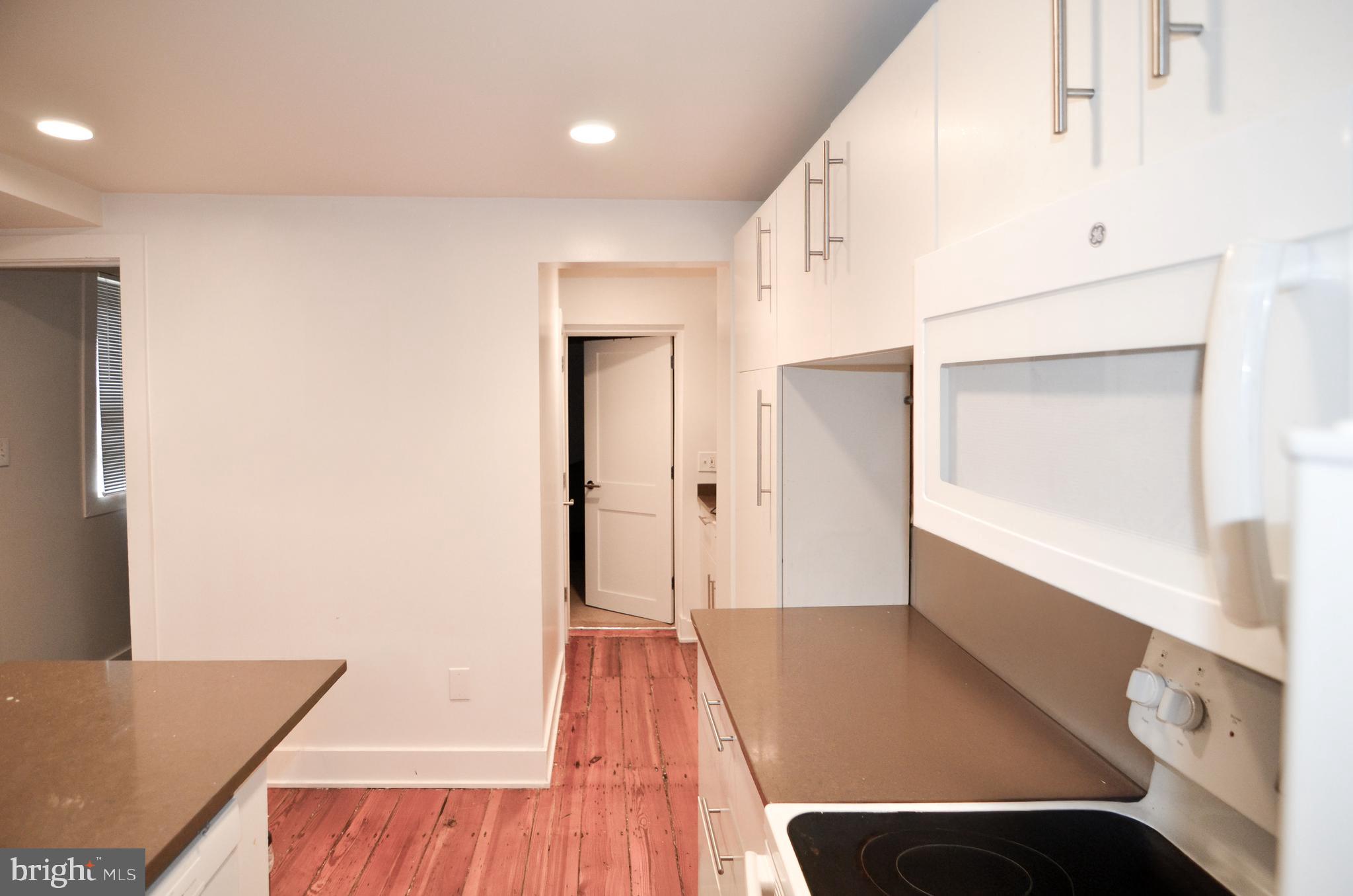 1072 Thomas Jefferson Street Northwest Washington, DC 20007 - Photo 7 of 58 a view of hallway with furniture and wooden floor