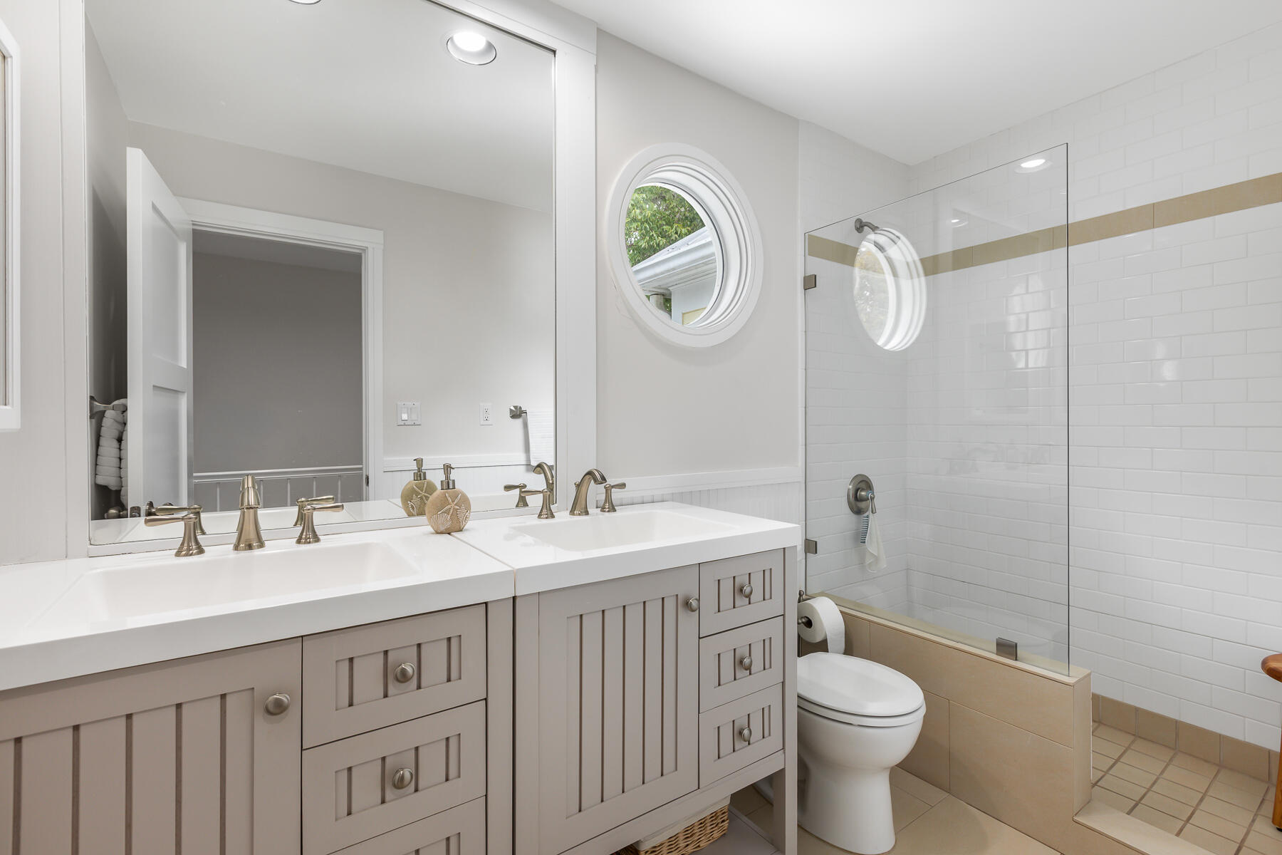 404 Porter Lane, Unit 16 Key West, FL 33040 - Photo 19 of 22 a bathroom with a double vanity sink toilet mirror and shower