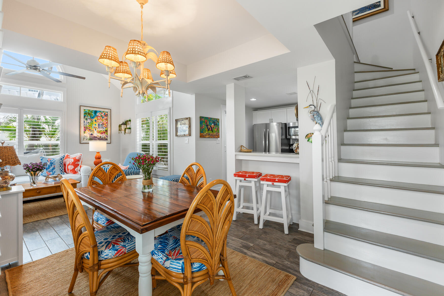 404 Porter Lane, Unit 16 Key West, FL 33040 - Photo 7 of 22 a dining room filled chandelier and wooden furniture
