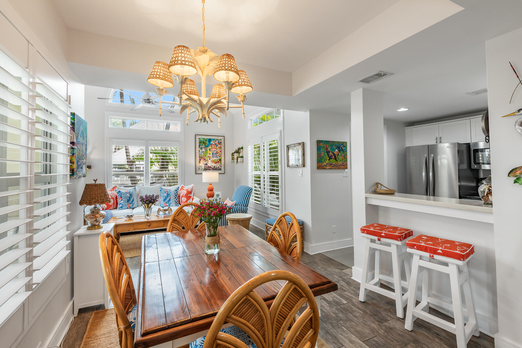 404 Porter Lane, Unit 16 Key West, FL 33040 - Photo 8 of 22 a view of a dining room and livingroom with furniture wooden floor a chandelier