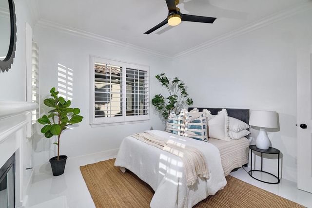 a bedroom with furniture and a large window