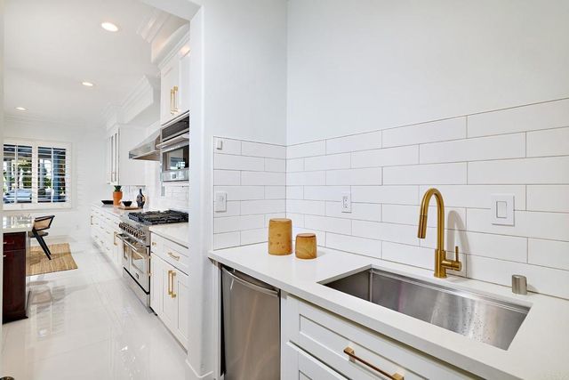 a kitchen with cabinets a sink and a stove top oven