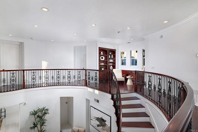 a view of entryway with wooden floor and stairs