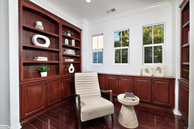 a room with furniture a bookshelf and a large window