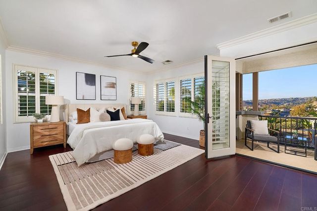 a bed room with furniture and a large window