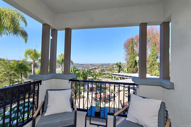 a view of a chair and table in the balcony