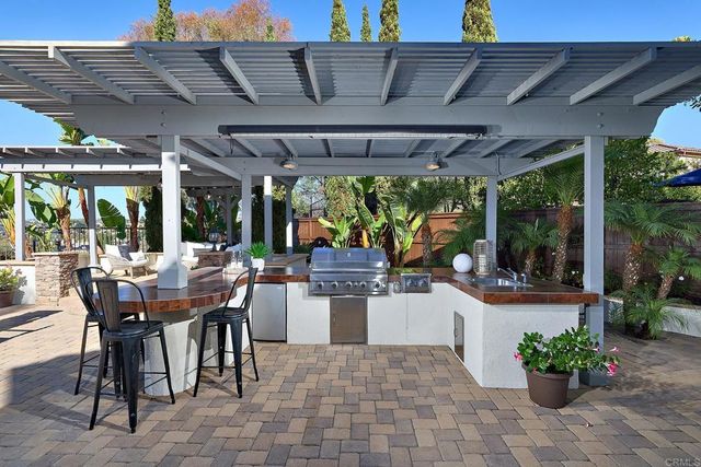 a view of a patio with table and chairs potted plants