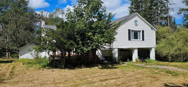 a view of a house with a yard covered in snow