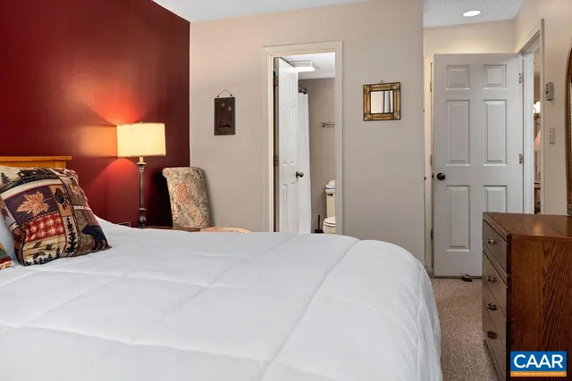 a bedroom with a bed and a lamp