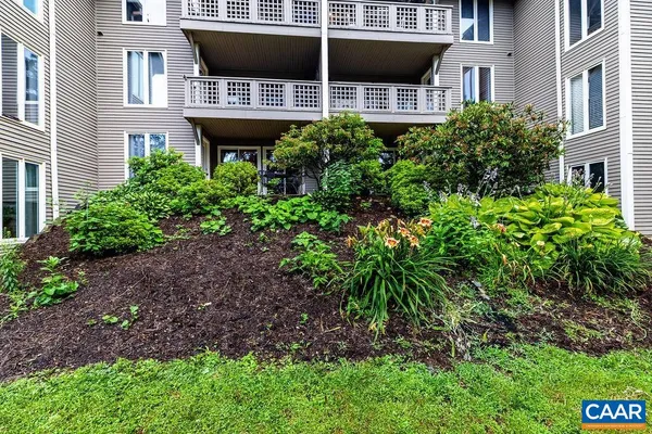 a view of a house with a yard and sitting space