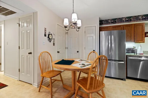 a dining room dining table chairs and a refrigerator