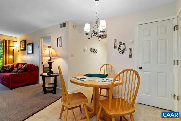 a view of a dining room with furniture wooden floor and a chandelier
