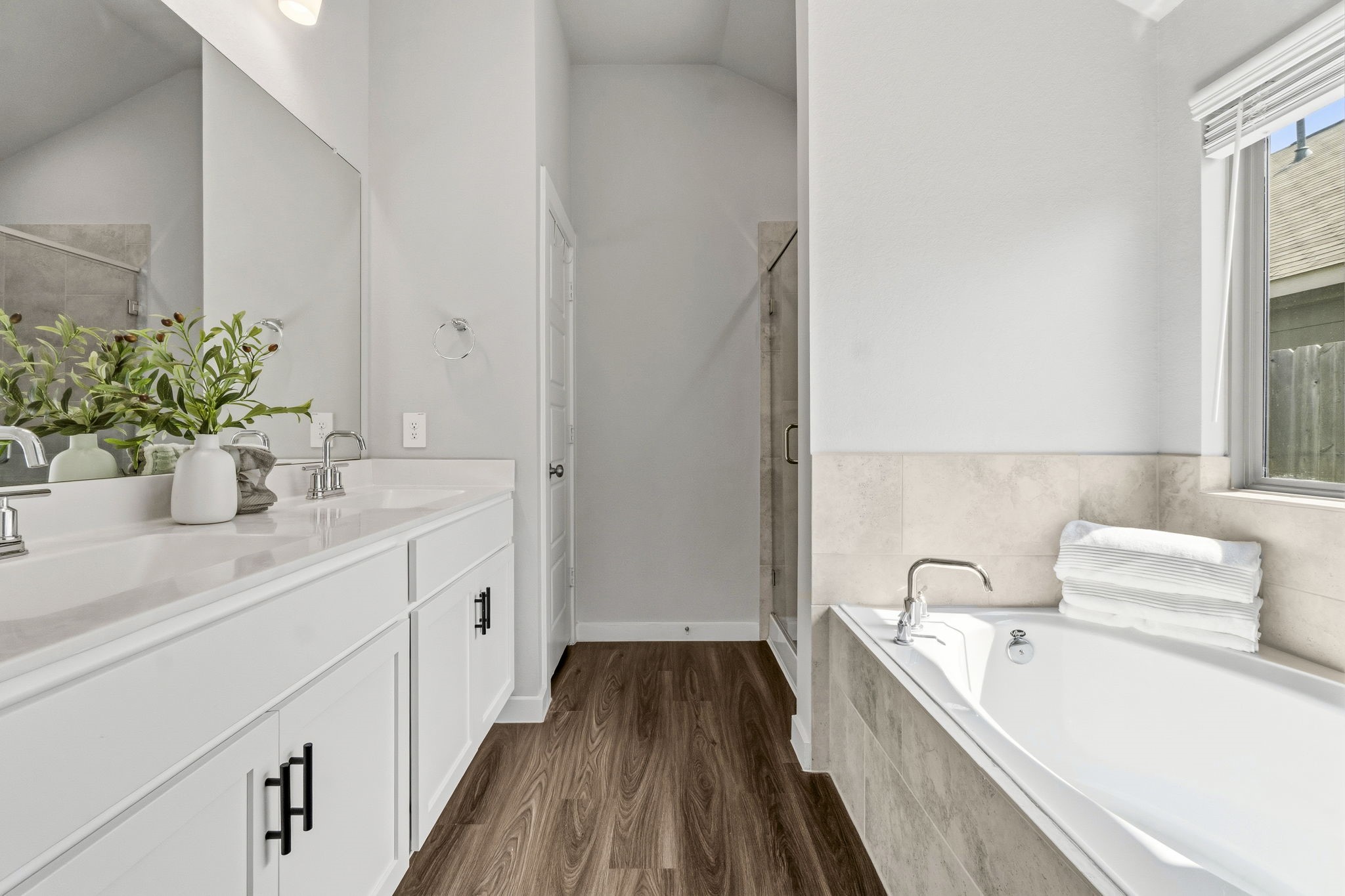 22235 Cardinal Crest Lane New Caney, TX 77357 - Photo 15 of 41 Spacious primary bathroom featuring a relaxing soaking tub, a separate glass-enclosed shower, dual vanities,