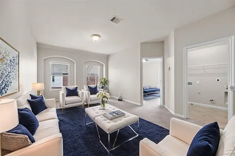 a living room with furniture and wooden floor