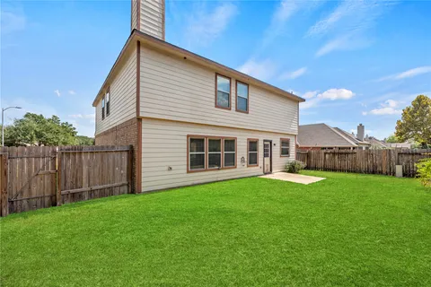 a backyard of a house with wooden fence