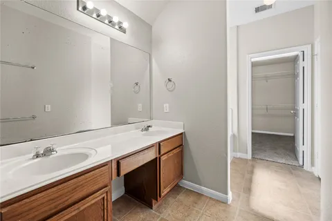 a bathroom with a sink double vanity and a mirror