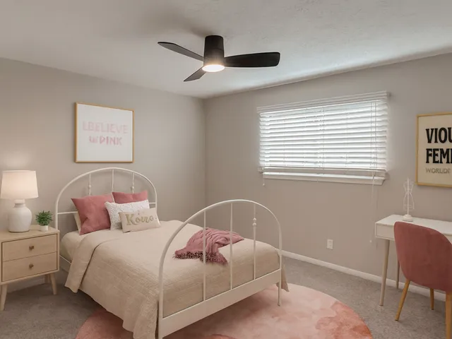 a bedroom with a bed and a chair