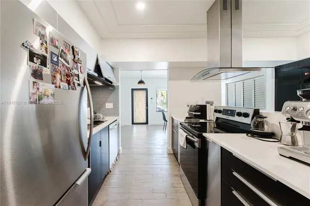 a kitchen with stainless steel appliances a sink and a refrigerator