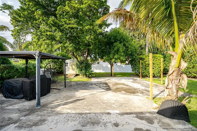 a view of a garden with a house