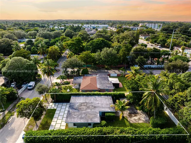 an aerial view of a house with a garden and trees