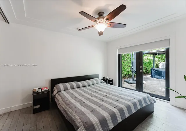 a bedroom with a large bed and a large window